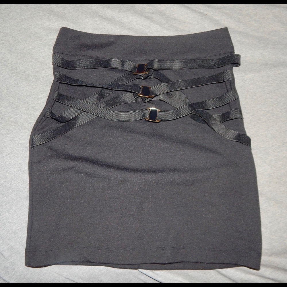 Black form fitting mini skirt with buckles